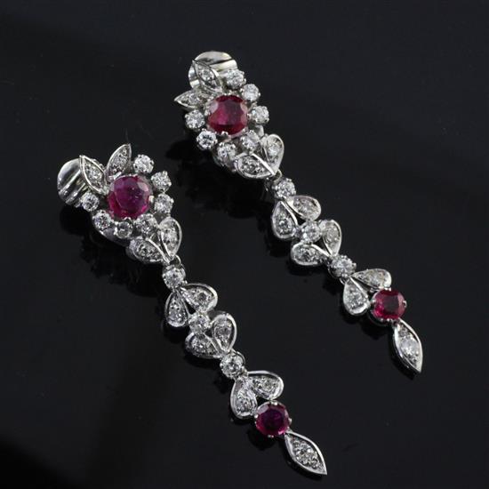 A pair of white gold, ruby and diamond cluster drop earrings, overall 2in.